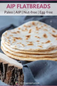 a stack of flatbreads sitting on top of a piece of wood