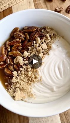 a bowl filled with oatmeal and nuts on top of a wooden table