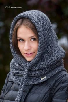 a woman wearing a hooded jacket and scarf