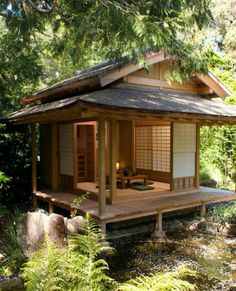 a small japanese style house in the woods