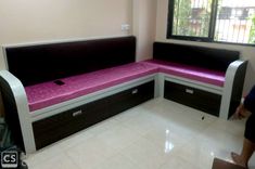 a purple and black bench sitting in front of a window next to a white tiled floor