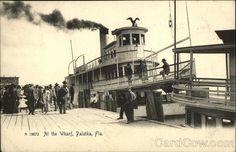 an old postcard shows people standing on the deck of a boat