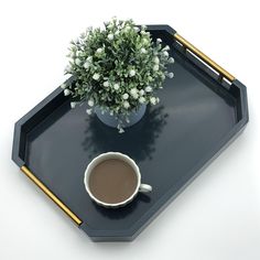 a tray with a cup of coffee and a potted plant