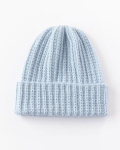 a light blue knitted beanie on a white background