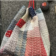 a handbag made out of woven material with red, white and blue designs on it