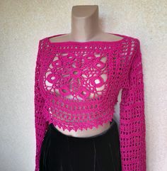 A fuchsia crochet mesh top sounds like a bold and stylish choice! The vibrant color will definitely make a statement, and the crochet mesh adds a fun, textured element to your outfit.  A granny square with a Celtic-inspired weave combined with a delicate mesh pattern and a cute border definitely makes for a unique and eye-catching top. The intricate design and attention to detail will certainly set it apart from more conventional garments. This is the perfect layering piece which completely tran Fitted Crochet Top With Granny Square For Spring, Fitted Long Sleeve Crochet Lace Crop Top, Trendy Fitted Open Knit Crochet Top, Fitted Long Sleeve Crochet Top For Festival, Stretch Crochet Top In Pink, Spring Cropped Stretch Crochet Top, Stretch Pink Crochet Top, Stretch Cropped Crochet Top For Spring, Stretch Cropped Open Knit Crochet Top