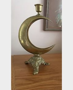 a brass colored candle holder with an elephant figurine on it