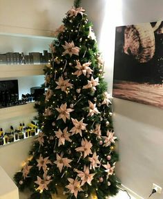 a christmas tree decorated with pink and white flowers