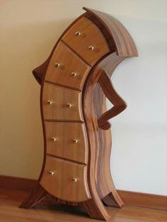 a wooden cabinet with many drawers on it's sides and an upside down shelf in the middle