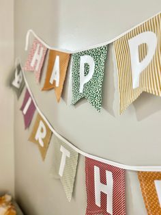 a happy birthday banner hanging on the wall