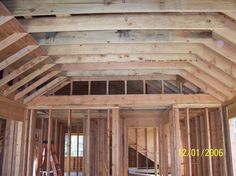 the inside of a house being built with wood framing on the walls and ceiling beams