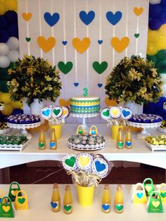 a table topped with lots of desserts and drinks on top of a white table