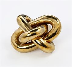 an image of a gold knot ring on a white background