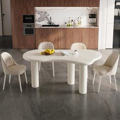 a white table and four chairs in a room with marble flooring on the walls