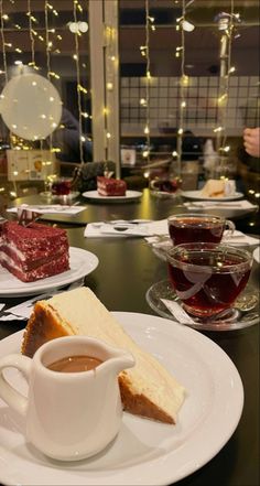 there is a piece of cake on the plate with a cup of tea in front of it