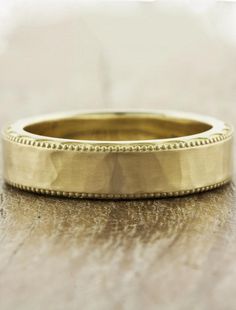 a gold wedding band with beaded edges