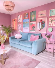 a pink and blue living room with pictures on the wall