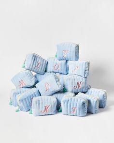 a pile of blue diapers with the letters d and n on them, all stacked together