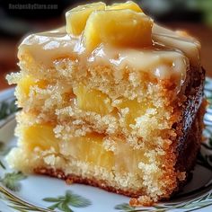 a piece of cake on a plate with some frosting and pineapple toppings