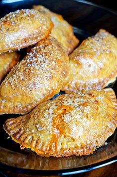 several pastries on a plate with powdered sugar