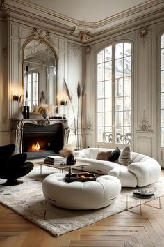 a living room filled with furniture and a fire place in the middle of the room