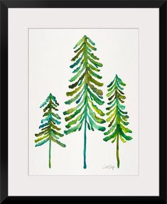 three watercolor pine trees on white paper with black border, framed in wooden frame