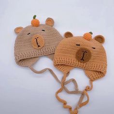 two crocheted hats with bears on them, one is brown and the other is tan