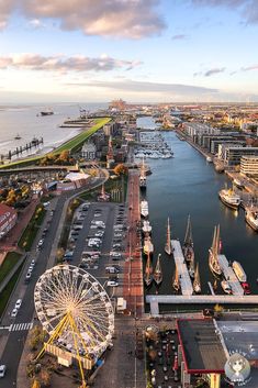 an aerial view of a harbor and ferris wheel