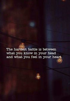 the light bulbs are hanging from wires with a quote on them that reads, the harlest battle is between what you know in your head and what you feel in your heart