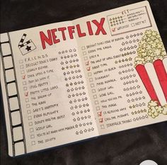 an open book with the words netflix written on it and a movie ticket next to it