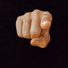 a close up of a person's fist on a black background