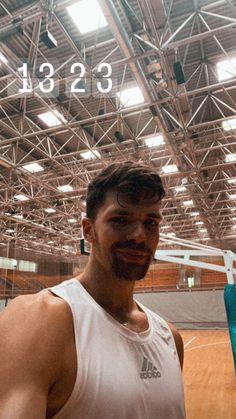 a man standing in front of a basketball court