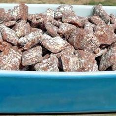 a blue bowl filled with dog food on top of a wooden table