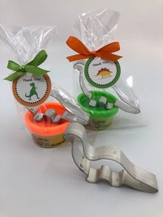 three cookie cutters and two small cupcake tins with thank you tags on them