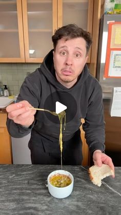 a man is eating soup from a bowl