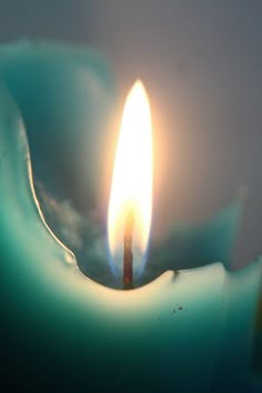 a candle is lit in the dark with water on it