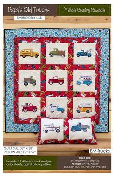 a quilted wall hanging with cars and trucks on it