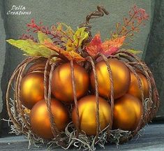 a basket filled with golden eggs sitting on top of a wooden floor next to a stone wall