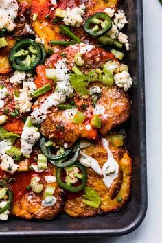 a pan filled with chicken and vegetables covered in sauce