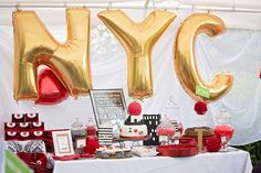 a table topped with balloons and cake next to a sign that says yyc