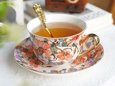 a cup of tea on a saucer with a spoon