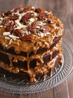 a chocolate cake with pecans and caramel drizzled on the top