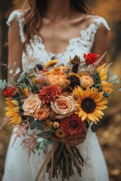 a bride holding a bouquet of sunflowers and roses