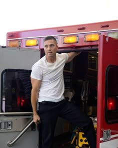 a man standing in the doorway of a fire truck