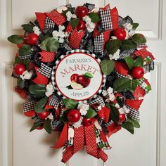 a red and black wreath with apples on it that says farmer's market apples