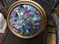 there is a clock that has been made out of many small pieces of glass and gold