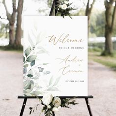 a welcome sign with white flowers and greenery