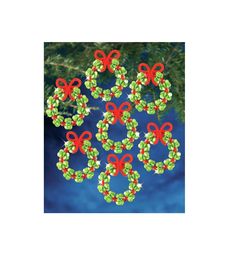 an image of christmas wreaths made out of beads and bows on a blue background