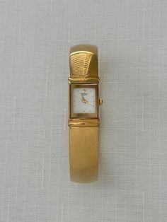 A unique chunky gold Seiko bangle watch that is the perfect statement accessory! Power: Quartz Total Inner Circumference: ~16.5cm (6.5") Case width (excluding crown): 1.2 cm The watch is working and a new battery has been installed in the watch. Overall in good condition, with some signs of wear (mainly some tiny scratches all around on the band). The crystal is almost perfect besides a few faint scratches. Please see pictures. Feel free to message me if you have any questions! Bangle Watches, Almost Perfect, Women Wrist Watch, Wrist Watches, Jewellery And Watches, Halloween Shopping, Womens Watches, Wrist Watch, Vintage Ladies