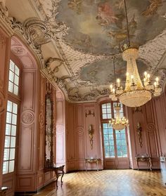 an ornate room with chandeliers and paintings on the ceiling, painted in pink